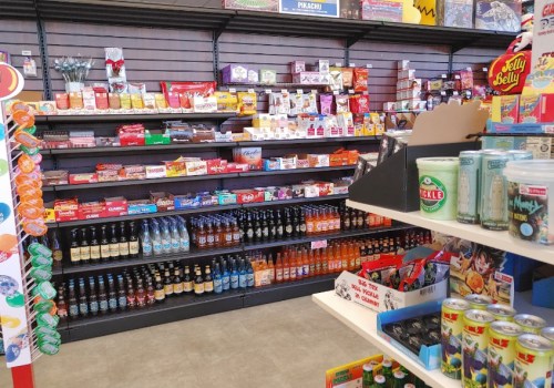 A colorful display of snacks and beverages on shelves in a store, featuring various candies, chips, and drinks.