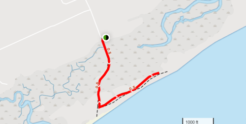 Map showing a coastal route with a red path, indicating a trail along the shoreline and nearby waterways.