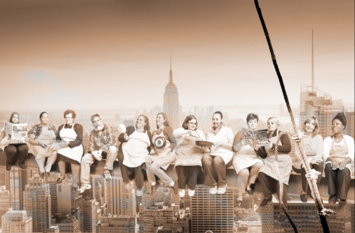 A diverse group of people in aprons sits on a beam above a city skyline, holding cooking magazines and smiling.