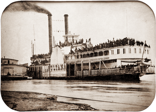 Historic photograph of the steamboat Sultana, crowded with passengers, docked by the river.