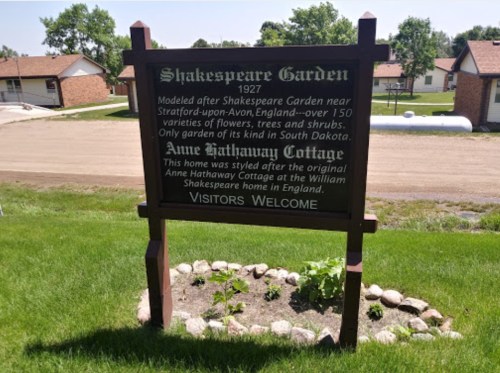 Sign for Shakespeare Garden, established in 1927, highlighting its features and welcoming visitors.