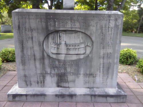 A stone monument with engraved text commemorating a site destroyed in April 1863, featuring a detailed illustration.