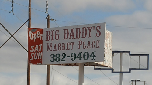 Sign for "Big Daddy's Market Place" with phone number 382-9404, indicating it's open on Saturdays and Sundays.