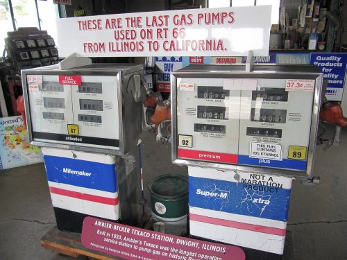 Vintage gas pumps with a sign reading "These are the last gas pumps used on RT 66 from Illinois to California."