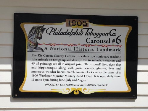 Sign for the 1905 Philadelphia Toboggan Co. Carousel #6, detailing its history and operation hours.