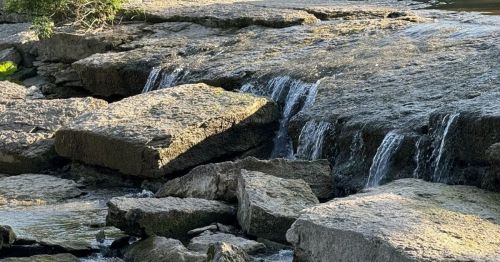 A waterfall flowing over rocks in Kansas