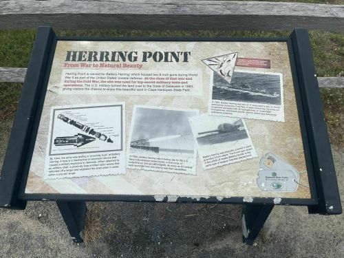 Informational sign about Herring Point, highlighting its history and natural beauty, with images and text.