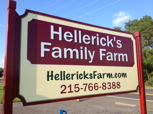 Sign for Hellerick's Family Farm with contact information and website displayed.