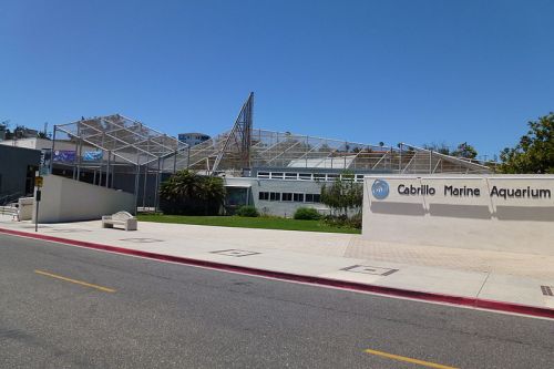 Cabrillo Marine Aquarium building with a modern design, featuring a glass roof and landscaped surroundings.