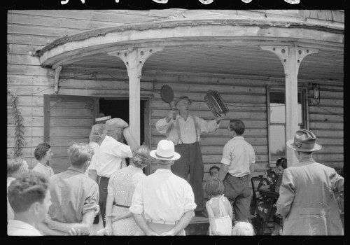 A crowd gathers around a man on a porch, holding instruments and speaking, with various people listening intently.