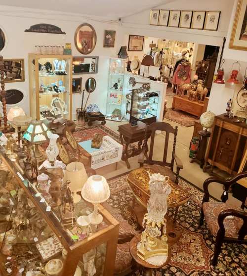A cozy antique shop filled with vintage furniture, decor, and collectibles, showcasing a warm, inviting atmosphere.