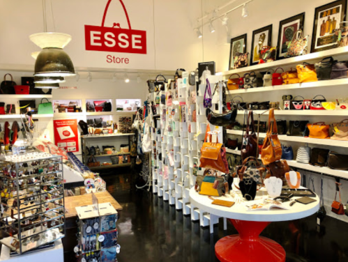 A vibrant store interior showcasing a variety of bags and accessories on shelves and displays.
