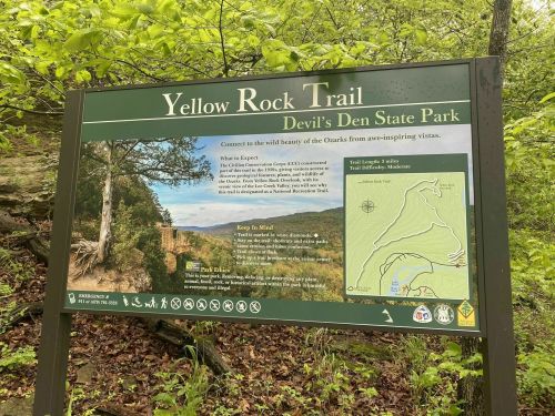 Sign for Yellow Rock Trail at Devil's Den State Park, detailing trail information and a map of the area.
