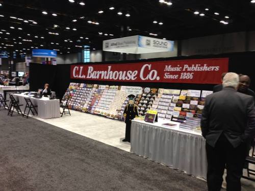 A trade show booth for C.L. Barnhouse Co. featuring music publications and a display of sheet music.