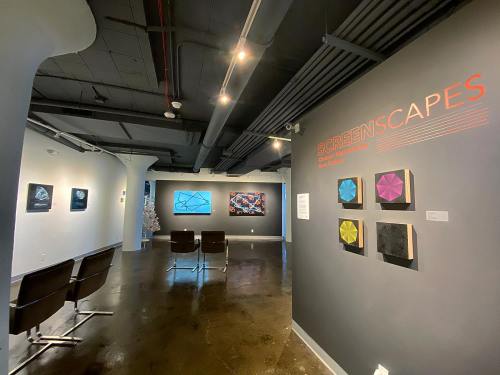 Art gallery interior featuring colorful abstract artworks and a sign for the "SCREENSCAPES" exhibition.