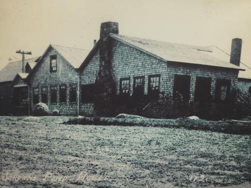 Black and white photo of a rustic wooden building with a stone chimney, labeled "Jenkins' Prop House."