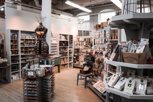 A cozy craft store filled with shelves of art supplies, tools, and decorative items, creating a creative atmosphere.