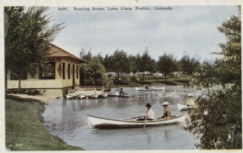 A vintage postcard depicting a boating scene at Lake Clara in Pueblo, Colorado, with several boats and a pavilion.