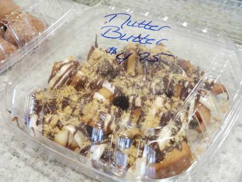 A clear container filled with Nutter Butter dessert, topped with chocolate and crushed cookies, priced at $4.75.