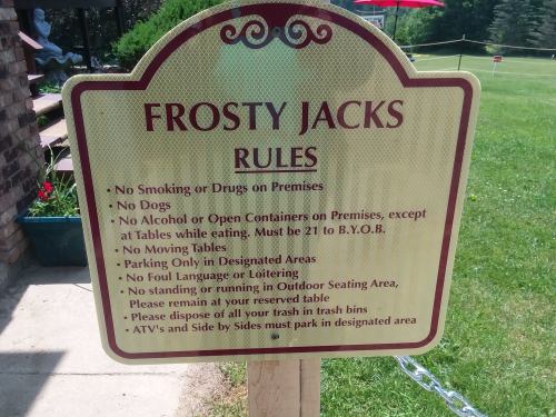 Sign listing rules for Frosty Jacks, including no smoking, no dogs, and parking instructions.