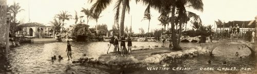 Vintage photo of Venetian Casino in Coral Gables, FL, featuring a scenic pool, palm trees, and people enjoying the water.