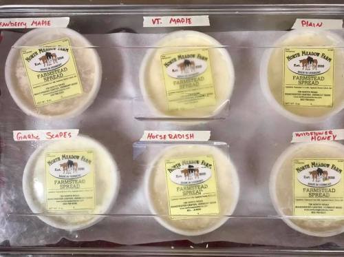 Six containers of farmstead spread labeled: Strawberry Maple, VT Maple, Plain, Garlic Grapes, Horseradish, and Wildflower Honey.