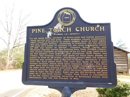 Sign for Pine Torch Church, detailing its history and significance in the local community since the early 1800s.