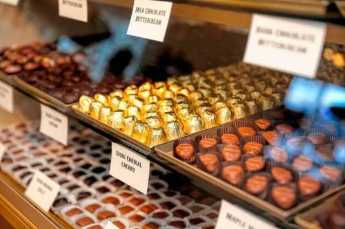 A display case filled with assorted chocolates, including milk chocolate, dark chocolate, and cherry varieties.