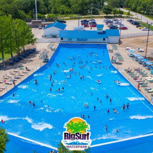 Aerial view of Big Surf Waterpark featuring a large wave pool filled with people enjoying the water.