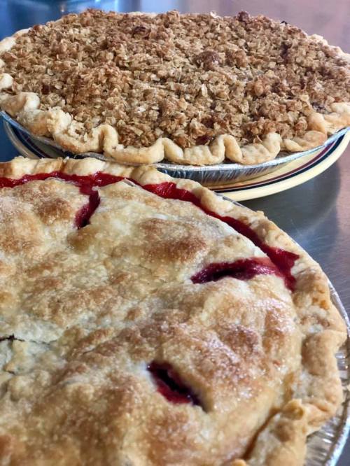 Two delicious pies: one with a flaky crust and cherry filling, the other topped with a crumbly oat topping.