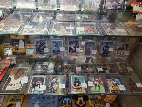 A display case filled with various sports trading cards, featuring players from different teams and eras.