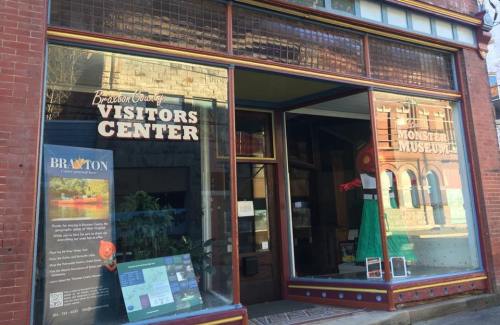 Exterior of the Braxton County Visitors Center, featuring a colorful display and a sign for the Monster Museum.