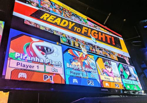 Screen displaying a Super Smash Bros. game selection with characters Piranha Plant, Banjo & Kazooie, and Mario.