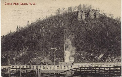 Historic black-and-white image of Queens Point, Keyser, West Virginia, featuring a factory and a mountainous backdrop.