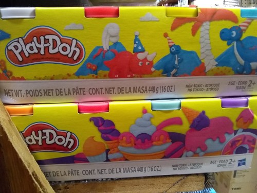 Colorful Play-Doh packaging featuring various fun shapes and characters, suitable for ages 2 and up.