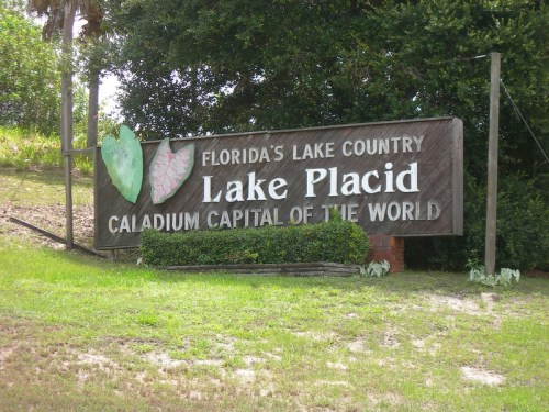 Sign for Lake Placid, Florida, highlighting it as the "Caladium Capital of the World" amidst greenery.