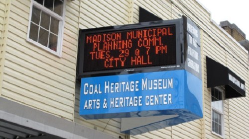 Sign displaying "Madison Municipal Planning Comm Tues 29 at 7 PM City Hall" outside the Coal Heritage Museum.