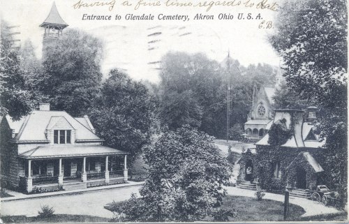 Black and white postcard of the entrance to Glendale Cemetery in Akron, Ohio, featuring trees and historic buildings.