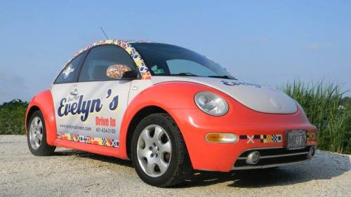 A colorful car with a red and white design, featuring the logo and name "Evelyn's Drive In" on the side.
