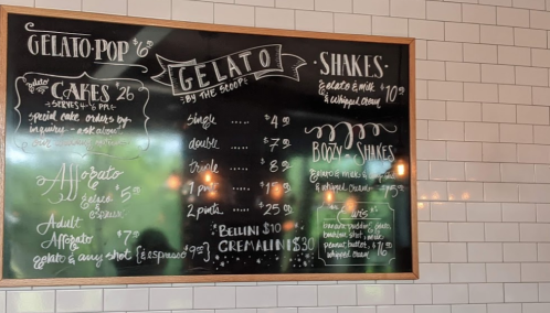 Chalkboard menu featuring gelato, shakes, and boozy shakes with prices and options listed.