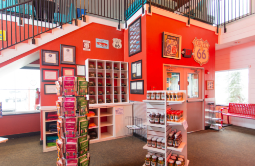 Interior of a Route 66-themed shop featuring colorful walls, shelves of products, and memorabilia on display.
