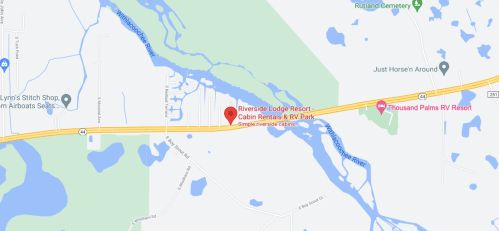 Map showing Riverside Lodge Resort and Thousand Palms RV Resort along a river, with nearby roads and landmarks.