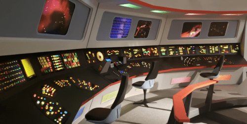 Futuristic control room with colorful buttons, screens, and a sleek design, resembling a spaceship cockpit.