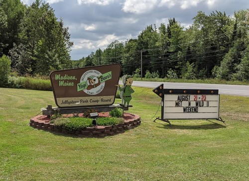Sign for Jellystone Park Camp-Resort in Madison, Maine, announcing "Wet & Wild Weekend" from August 21-23.