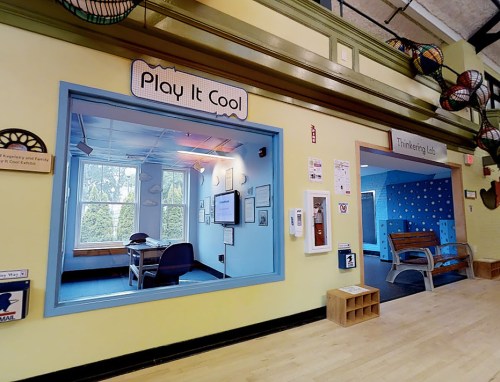 Brightly colored room with two areas: "Play It Cool" and "Thinking Lab," featuring playful decor and a cozy atmosphere.