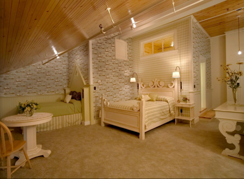 Cozy bedroom with two beds, soft lighting, floral wallpaper, and a warm, inviting atmosphere.