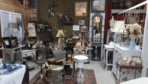 A cozy vintage shop filled with various antique furniture, decor items, and decorative accessories.