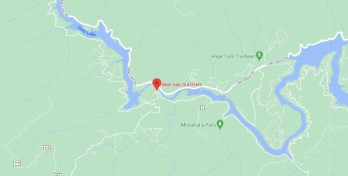 Map showing Bear Gap Outfitters location near a lake and trails, surrounded by green terrain and water features.