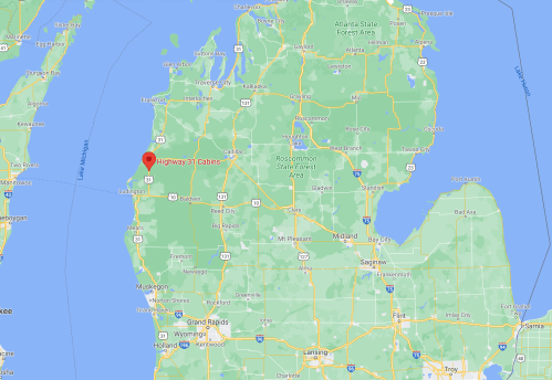 Map showing a location marked in red on the northwest coast of Michigan, near Lake Michigan.