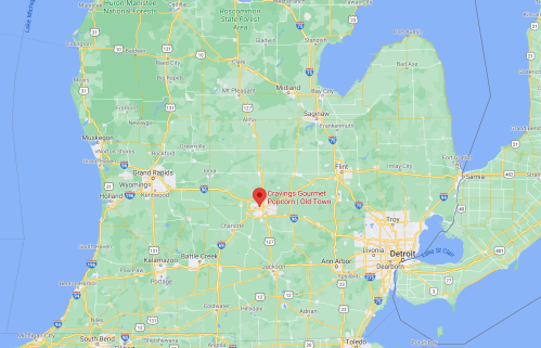 Map showing Michigan with a red marker indicating the location of Cravings Gourmet Popcorn in Old Town.